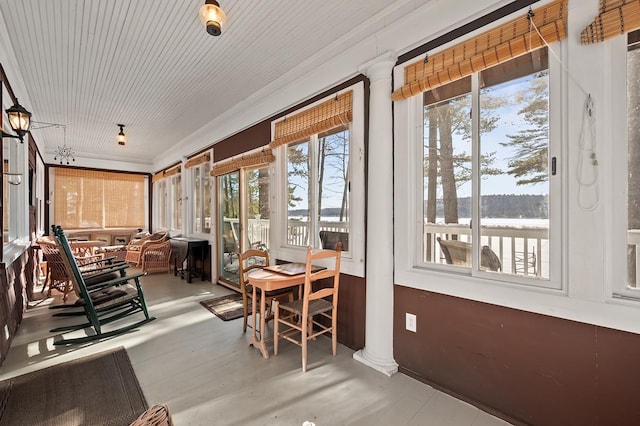 sunroom featuring ornate columns and a wealth of natural light