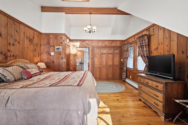 bedroom with vaulted ceiling with beams, a chandelier, light wood-style flooring, wooden walls, and baseboard heating