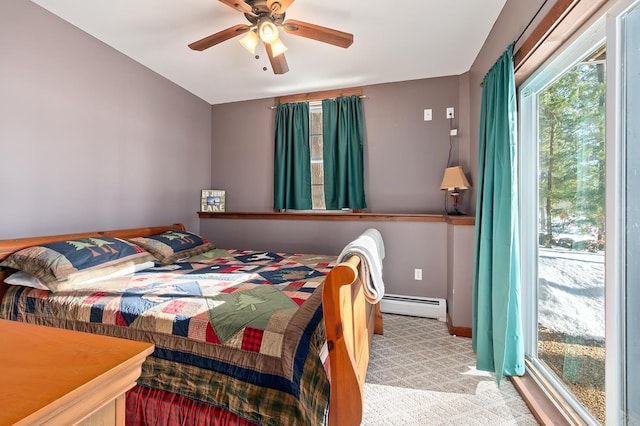 carpeted bedroom with ceiling fan, a baseboard radiator, and baseboards