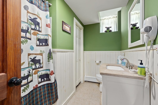 full bath featuring wainscoting, vanity, and tile patterned floors