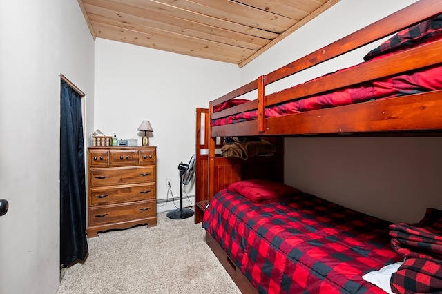 carpeted bedroom featuring a baseboard radiator, wooden ceiling, and vaulted ceiling