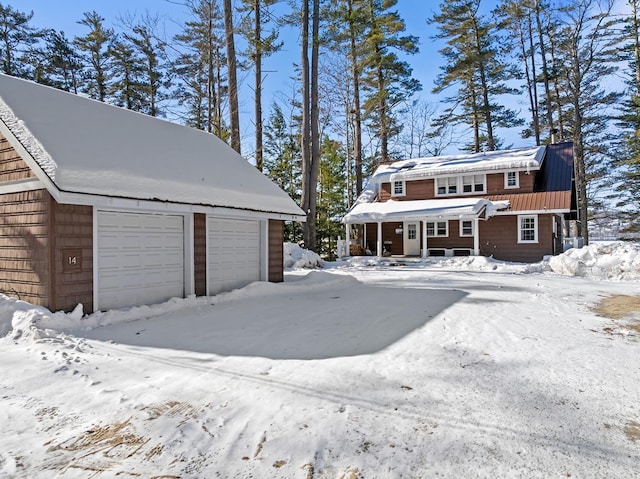 snow covered garage with a garage