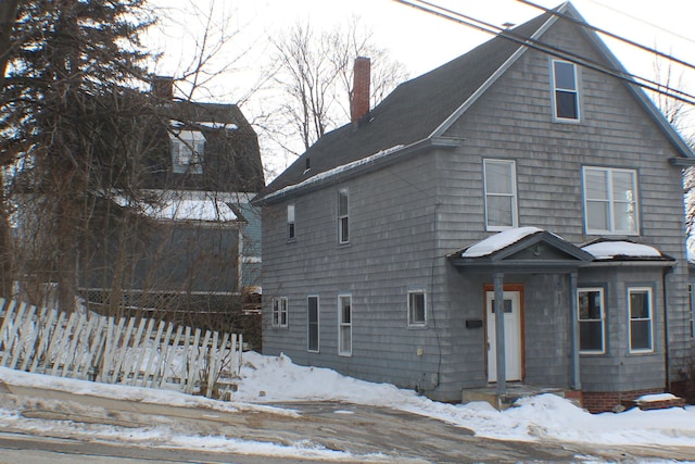 view of front of property featuring fence and a chimney