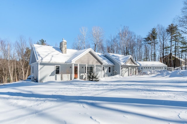 exterior space with an attached garage and a chimney