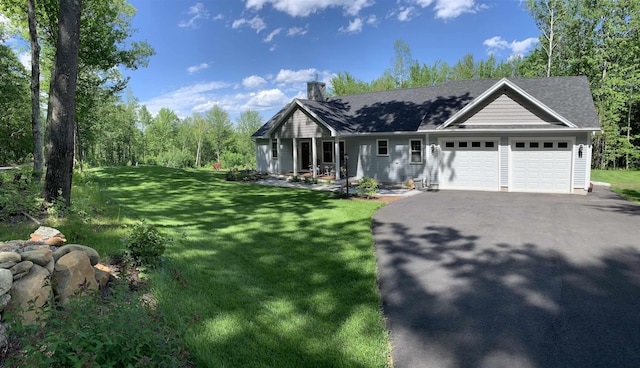 view of front facade featuring aphalt driveway, an attached garage, and a front lawn