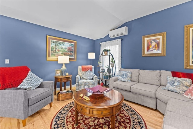 living room with lofted ceiling, an AC wall unit, light wood-style flooring, and baseboards