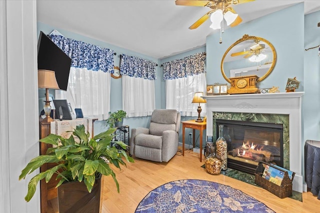 sitting room featuring a fireplace and wood finished floors