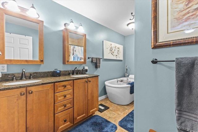 full bathroom with double vanity, a soaking tub, tile patterned flooring, and a sink