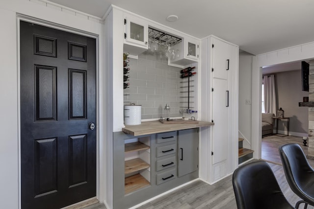 interior space with tasteful backsplash and wood finished floors