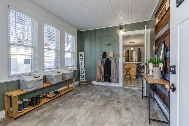 mudroom featuring wood ceiling, wood walls, and wood finished floors