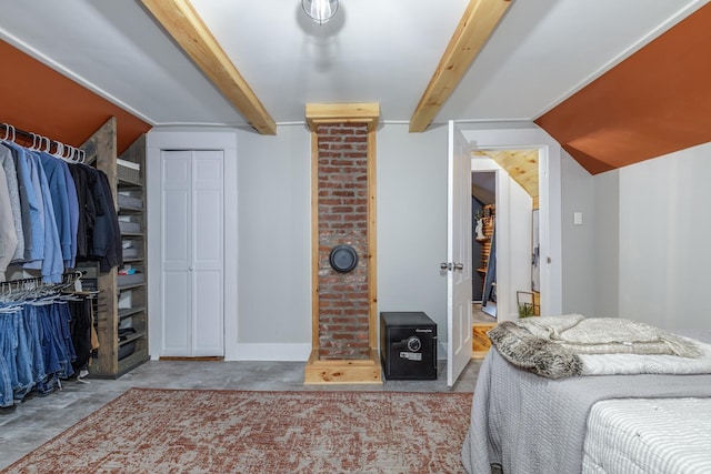 bedroom featuring concrete floors, baseboards, and beam ceiling