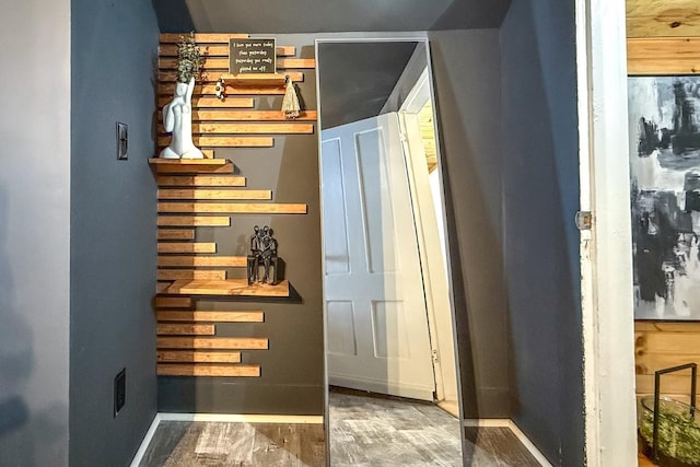 interior space with baseboards and wood finished floors