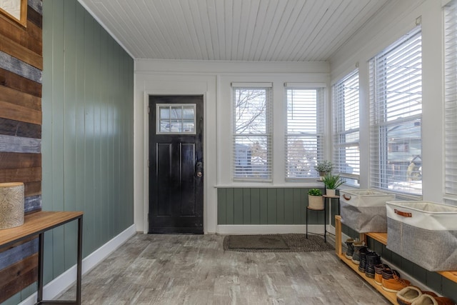 entrance foyer with wooden ceiling, baseboards, and wood finished floors