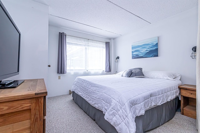 bedroom with a textured ceiling and carpet flooring