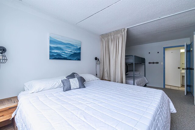 bedroom featuring a textured ceiling and carpet