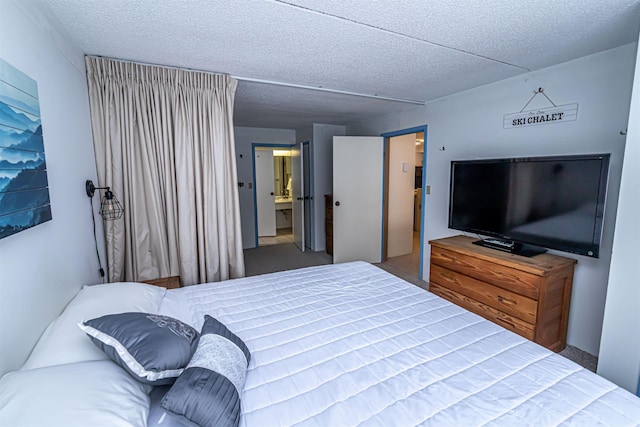 carpeted bedroom featuring a textured ceiling