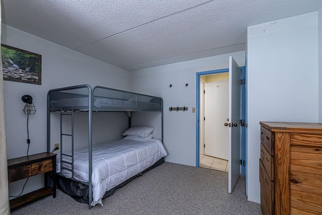 bedroom with carpet and a textured ceiling