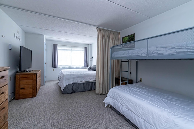 bedroom with carpet floors and a textured ceiling