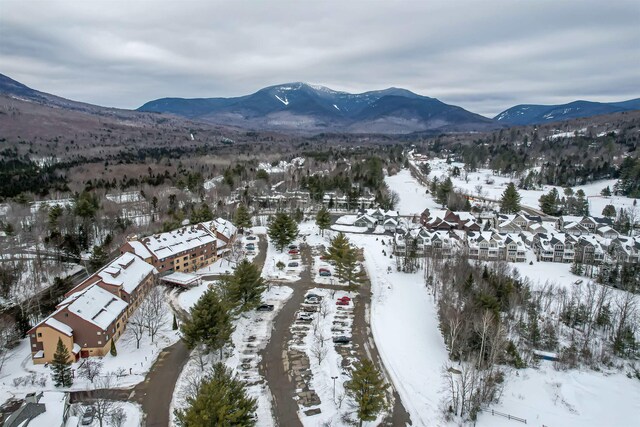 snowy aerial view featuring a residential view and a mountain view