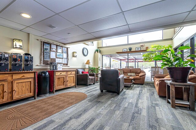 interior space with brown cabinetry, a drop ceiling, and visible vents