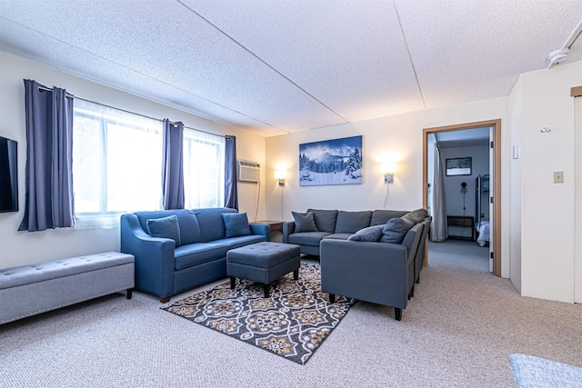 carpeted living room featuring a textured ceiling and a wall mounted air conditioner