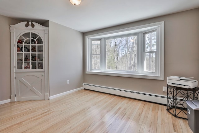 dining area featuring a wealth of natural light, baseboards, and wood finished floors