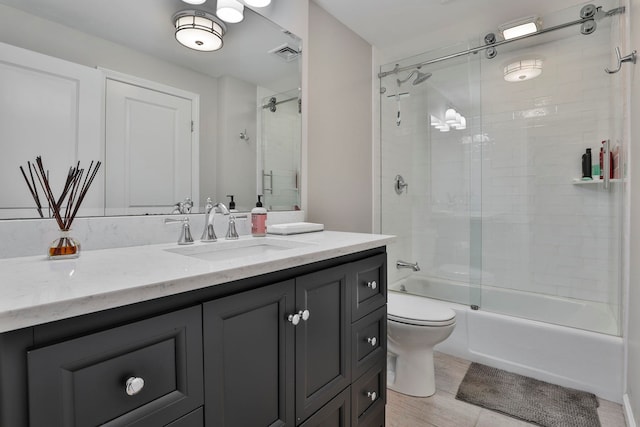 bathroom with visible vents, vanity, toilet, and bath / shower combo with glass door