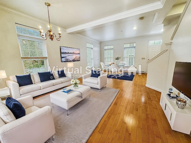 living area featuring a wealth of natural light, crown molding, and light wood finished floors