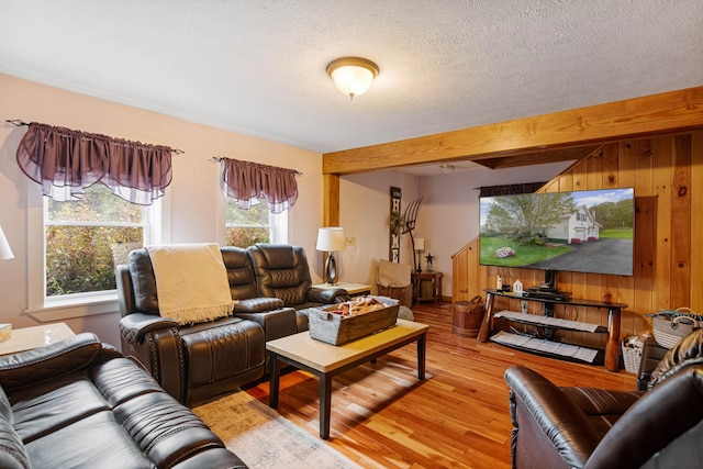 living room with a textured ceiling and light wood finished floors