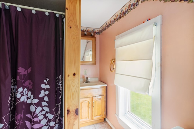 bathroom featuring curtained shower and vanity