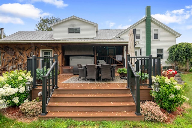 back of house with outdoor dining space, metal roof, and a wooden deck