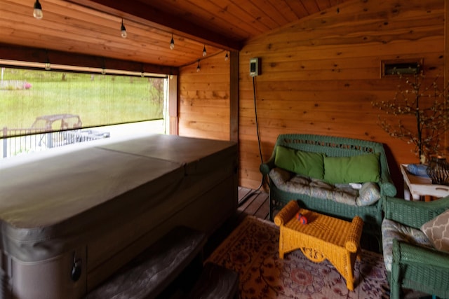 bedroom featuring wood walls, wood ceiling, and vaulted ceiling