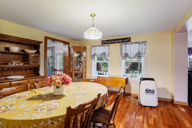 dining area featuring baseboards and wood finished floors