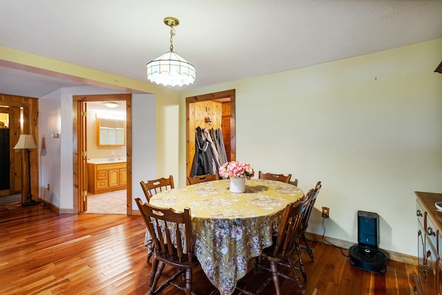 dining room with light wood-style floors and baseboards