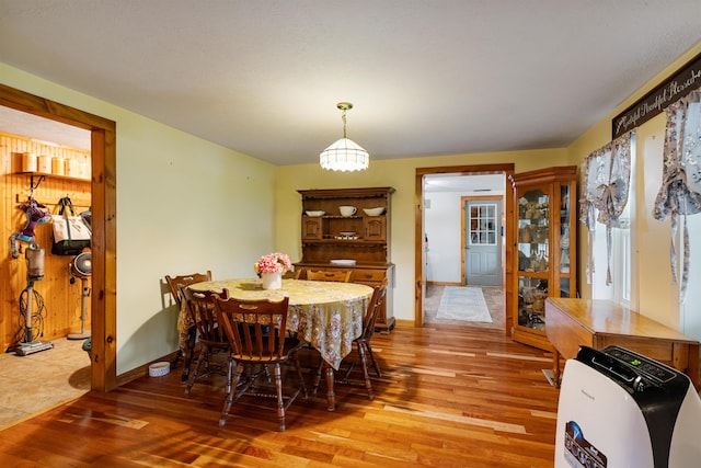 dining room with light wood-type flooring and baseboards