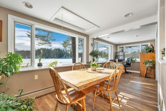 dining area with a baseboard radiator, recessed lighting, attic access, wood finished floors, and baseboards