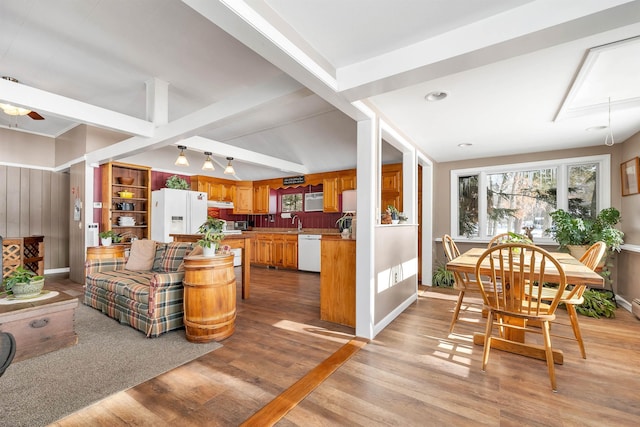 interior space featuring light wood-style floors, baseboards, ceiling fan, and beamed ceiling