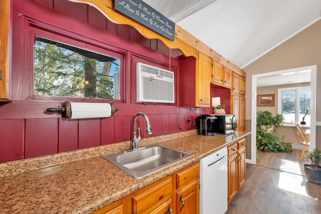 kitchen featuring tasteful backsplash, dishwasher, lofted ceiling, an AC wall unit, and a sink