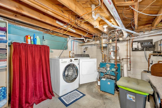 unfinished basement featuring a heating unit and washer and clothes dryer