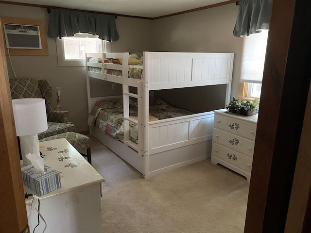 carpeted bedroom featuring ornamental molding and a wall mounted AC