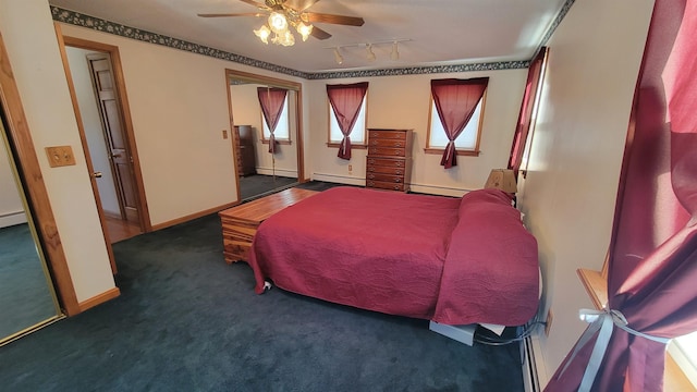 carpeted bedroom with baseboards, a ceiling fan, a baseboard radiator, rail lighting, and a baseboard heating unit