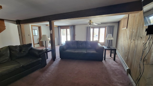 carpeted living room with beamed ceiling, baseboard heating, and ceiling fan