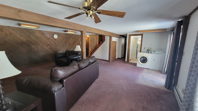 carpeted living area with stairway, independent washer and dryer, baseboard heating, wood walls, and beam ceiling