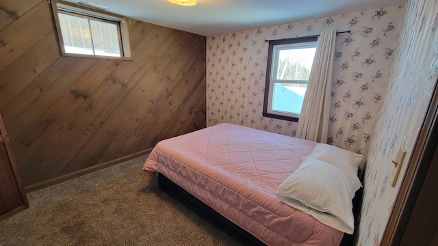 bedroom with carpet floors, wallpapered walls, and baseboards