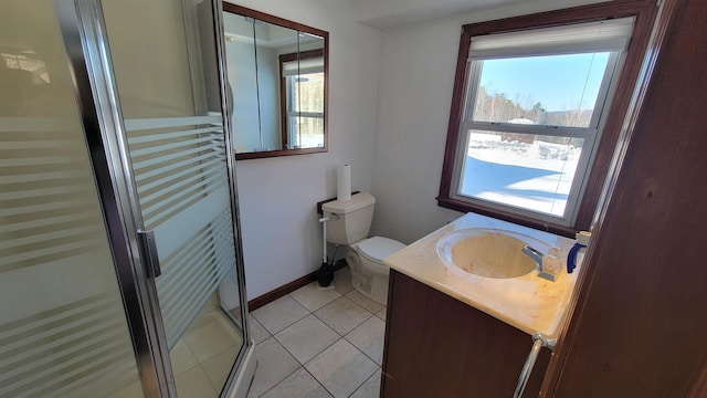 full bathroom with toilet, tile patterned flooring, vanity, and a healthy amount of sunlight