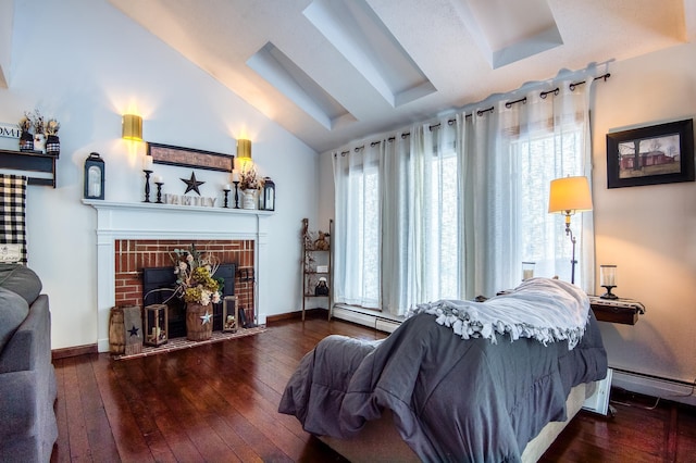 bedroom featuring multiple windows, vaulted ceiling, a fireplace, and hardwood / wood-style flooring