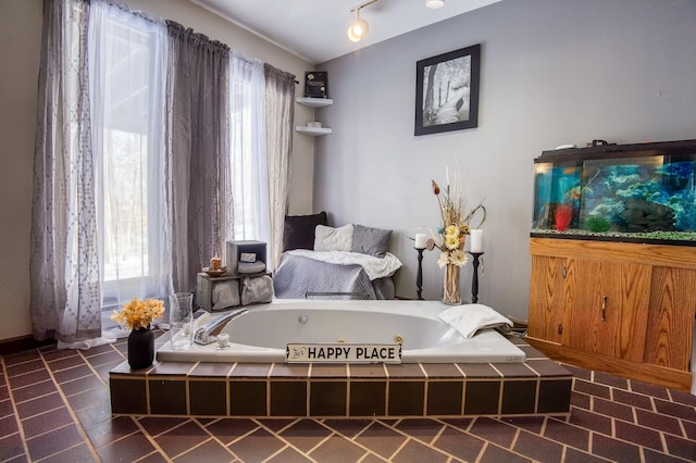 bedroom featuring rail lighting