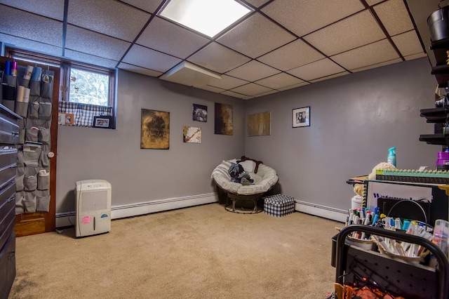 recreation room featuring a drop ceiling, baseboard heating, and carpet flooring