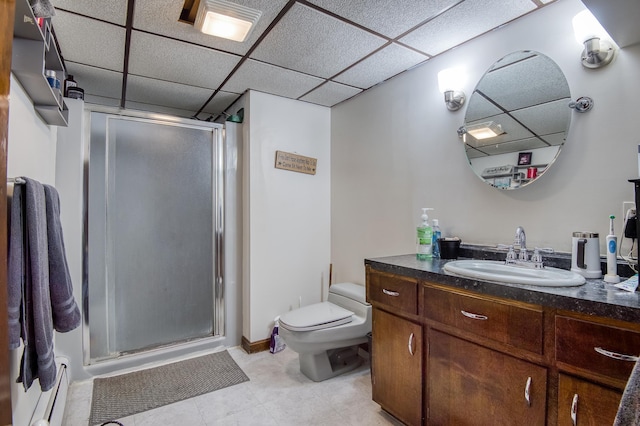 full bathroom featuring a drop ceiling, a baseboard radiator, toilet, vanity, and a shower stall