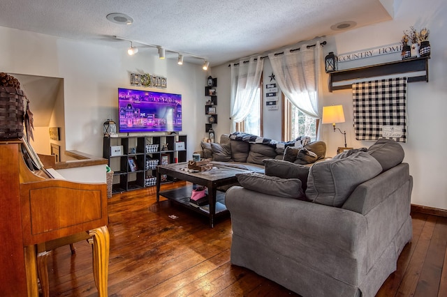 living area with rail lighting, a textured ceiling, and hardwood / wood-style flooring